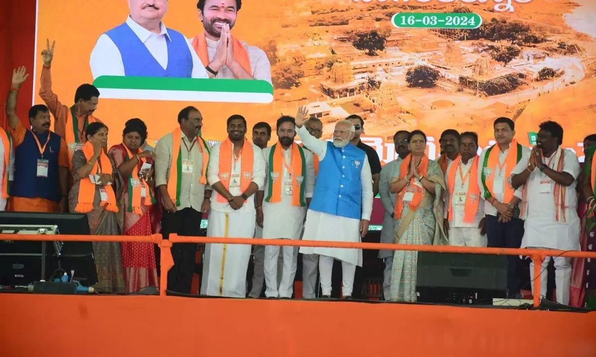 Prime Minister Narendra Modi waves at supporters during a public meeting ahead of Lok Sabha elections, in Nagarkurnool on Saturday. Union Minister and Telangana BJP president G Kishan Reddy and senior leader D K Aruna are also seen. Photo: Srinivas Setty