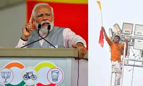 Get down, Modi appeals to supporters on flood-lit tower