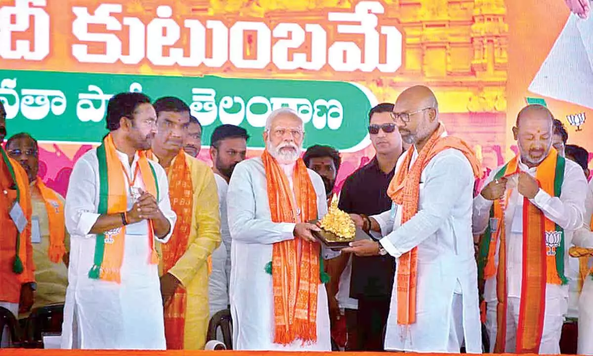 Prime Minister Narendra Modi with Union Minister and BJP Telangana president G Kishan Reddy, and BJP MPs Dharmapuri Arvind and Bandi Sanjay Kumar during a public meeting ahead of Lok Sabha elections, in Jagtial on Monday 				    Photo: Srinivas Setty