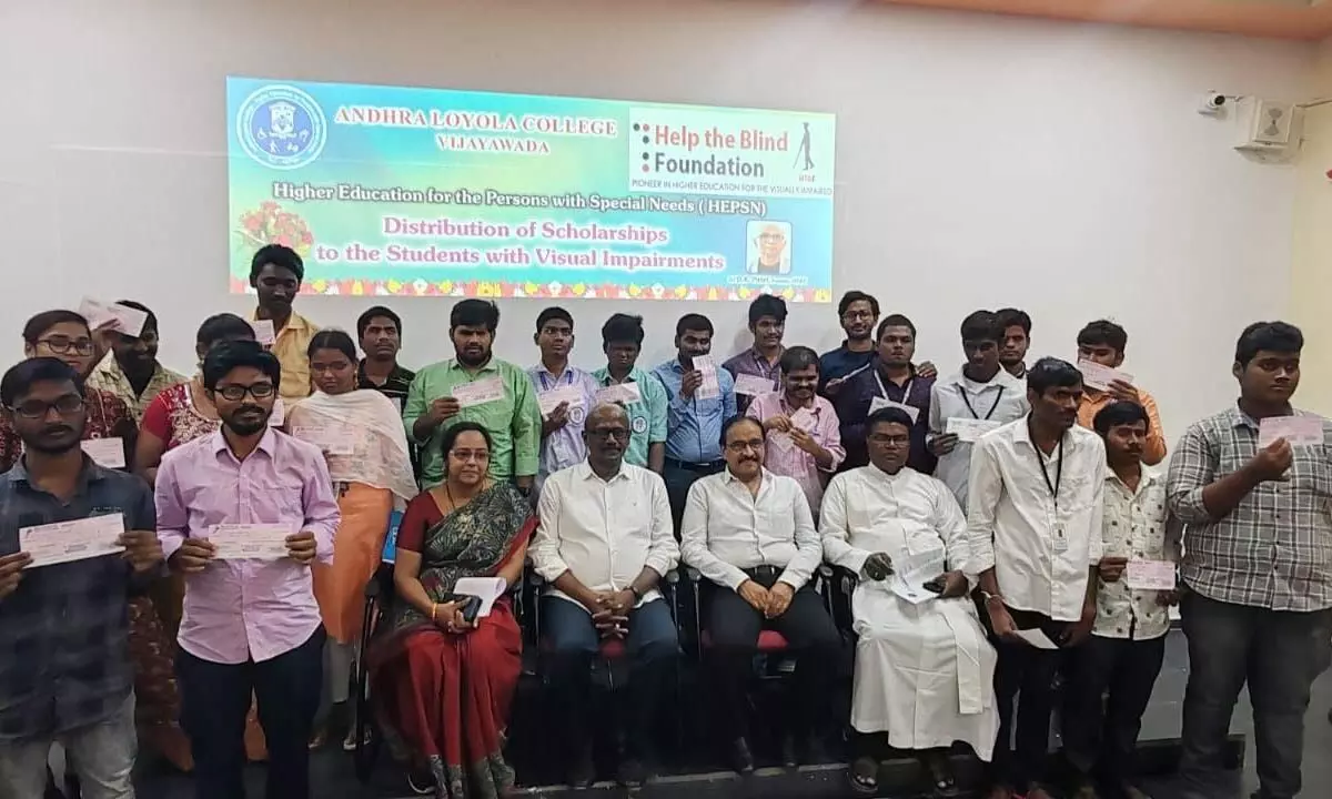 Visually-challenged students of Andhra Loyola College receiving scholarships on Tuesday