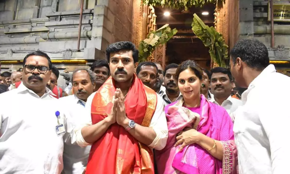 Film actor Mega power star Ram Charan Couple offered prayers at Tirumala temple, fans flock to see actor
