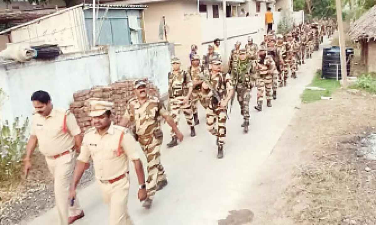 Police and armed forces conducting foot patrolling in a village in Eluru district on Sunday