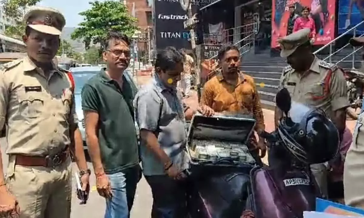Dwarka police seizing cash in Visakhapatnam on Tuesday