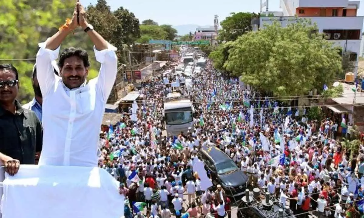 CM Jagan Mohan Reddy greeting the people during a roadshow in Srikalahasti constituency on Thursday