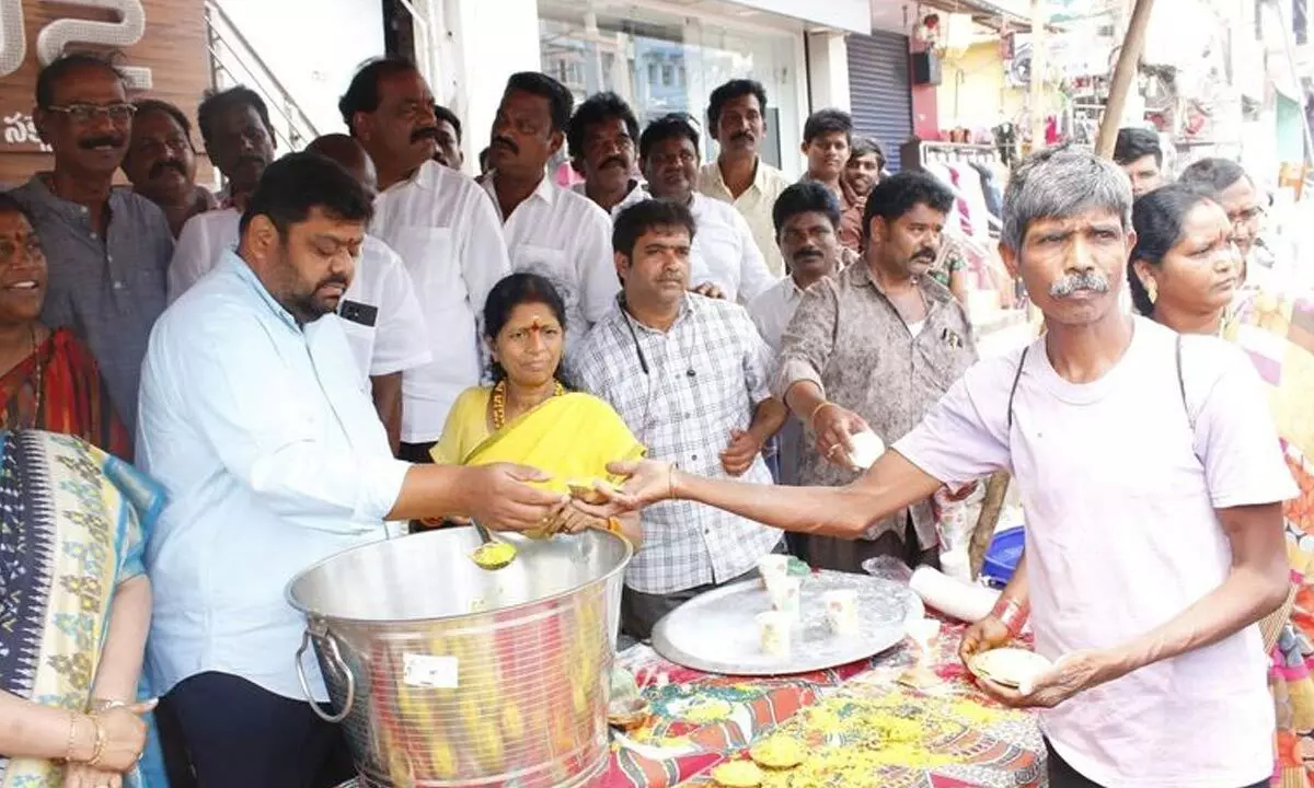 YSRCP West constituency candidate Adari Anand Kumar serving food at a temple in Visakhapatnam on Monday