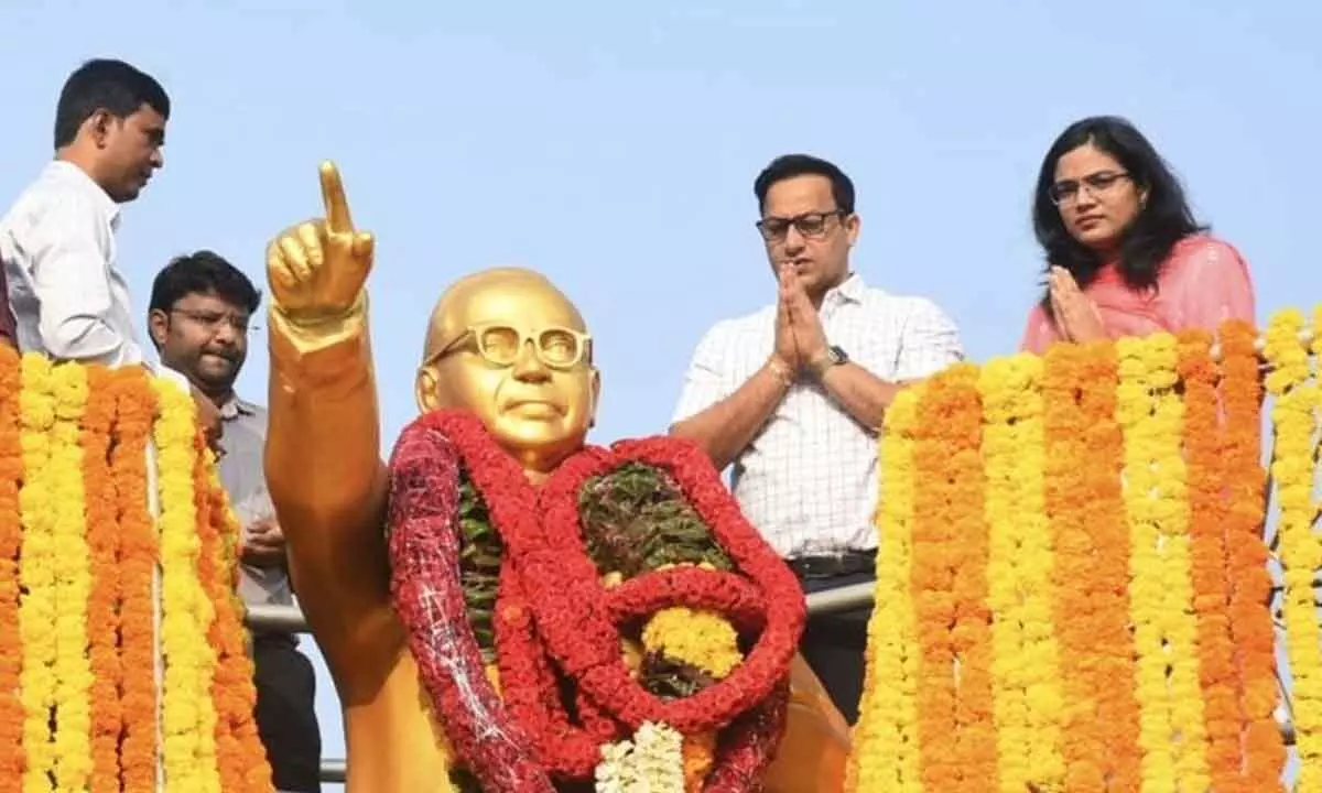 District Collector Praveen Kumar and Municipal Corporation Commissioner Aditi Singh garlanding the statue of Dr BR Ambedkar at RTC bus stand circle in Tirupati on Sunday