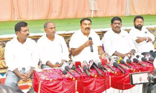 Minister Merugu Nagarjuna addressing a press conference in Ongole on Sunday