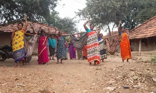 Carrying ‘dolis,’ tribals take part in a protest in Anakapalli district