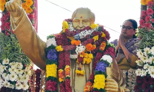 District Collector Dr G Srijana garlanding the statue of Dr BR Ambedkar at old bus stand in Kurnool on Sunday