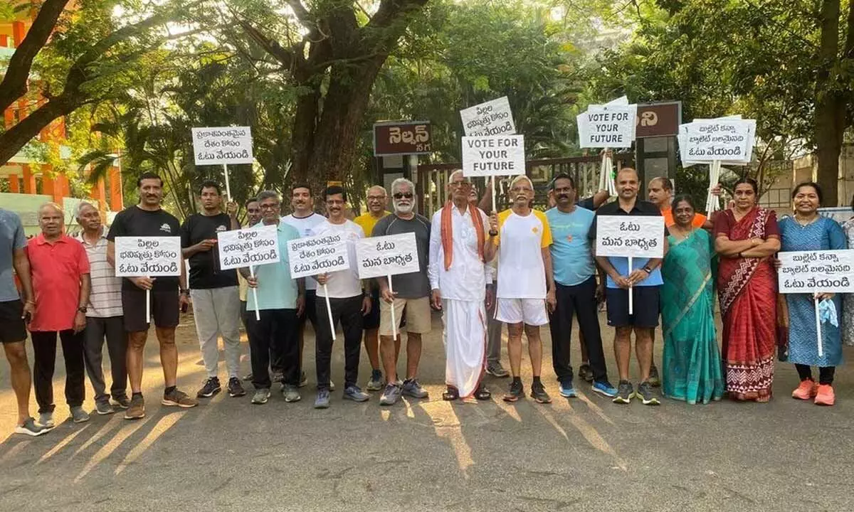 The members of Amaravati Runners Association going around LIC Colony in Vijayawada on Tuesday asking people to participate in the democratic process of election by exercising their franchise on Tuesday