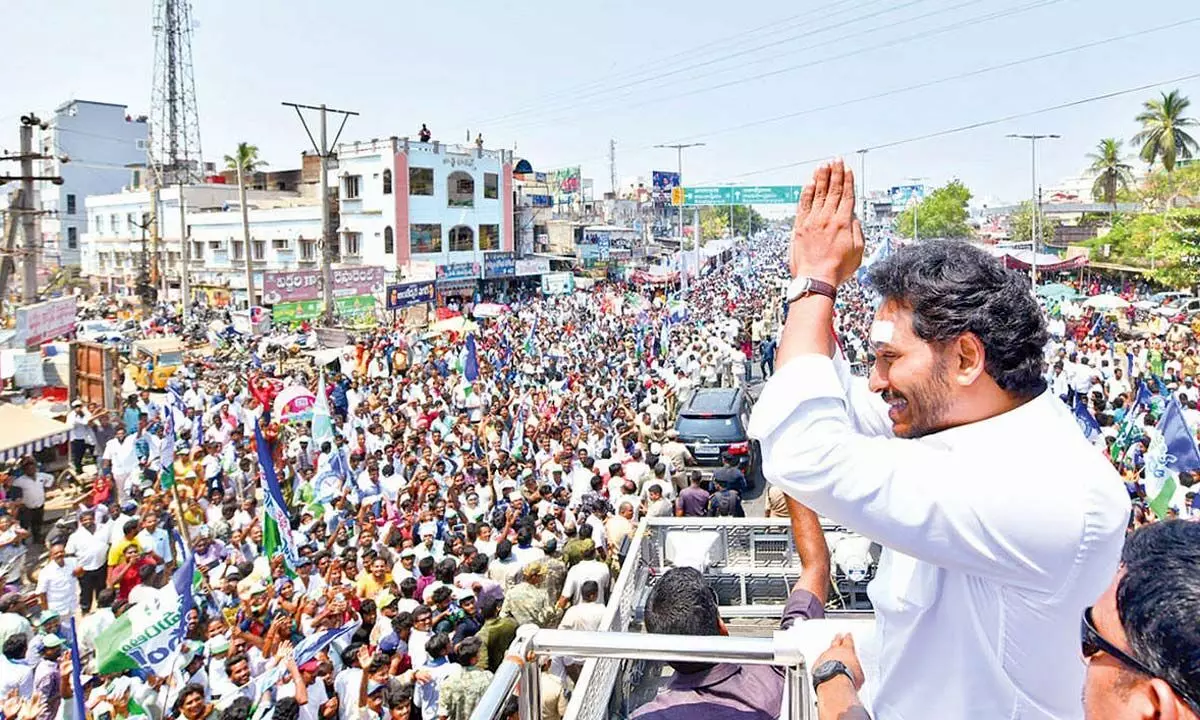 Chief Minister Y S Jagan Mohan Reddy greets people at Ravulapalem during Memantha Siddham bus yatra on Thursday