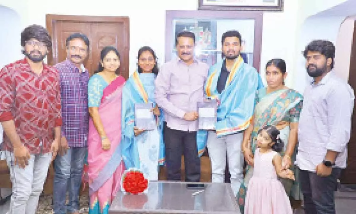 Justice EV Venugopal felicitating civils rankers Nandala Saikiran and Kolanupaka Sahana at his residence in Mankammathota in Karimnagar on Sunday