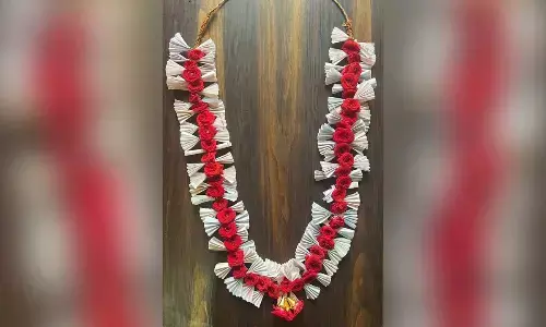 CM Siddaramaiah receives a garland made of free bus tickets