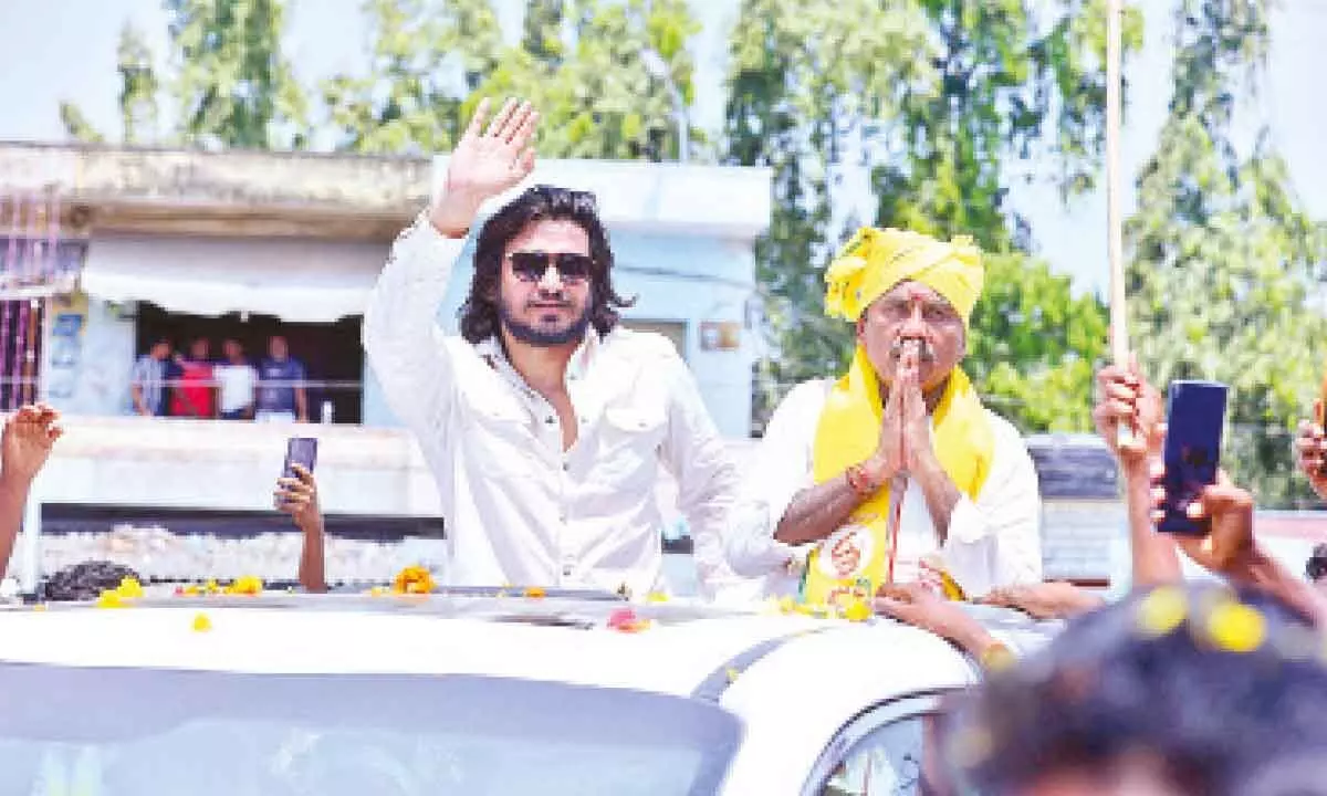 Cine artist Nikhil Siddharth waving to public and requesting them to vote for TDP candidate MM Kondaiah in Chirala on Thursday