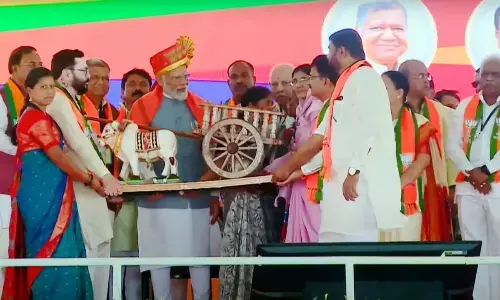 Prime Minister Narendra Modi being presented a memento during a public meeting for  Lok Sabha polls, in Belagavi, Karnataka on Sunday