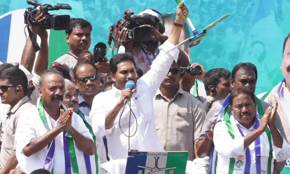 Chief Minister YS Jagan Mohan Reddy greeting people during a road show at Chodavaram in Anakapalli district on Monday