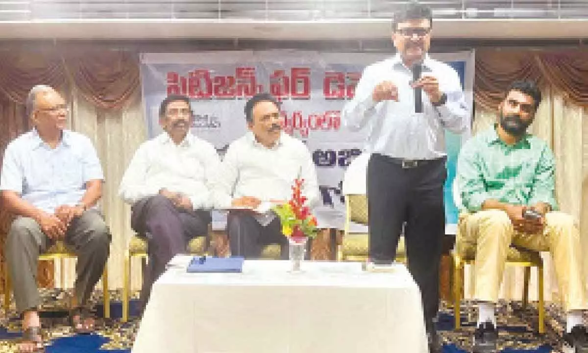 Former special chief secretary Dr P V Ramesh speaking at a meeting in Tirupati on Thursday. Joint secretary of Citizens for Democracy V Lakshman Reddy and others are seen.