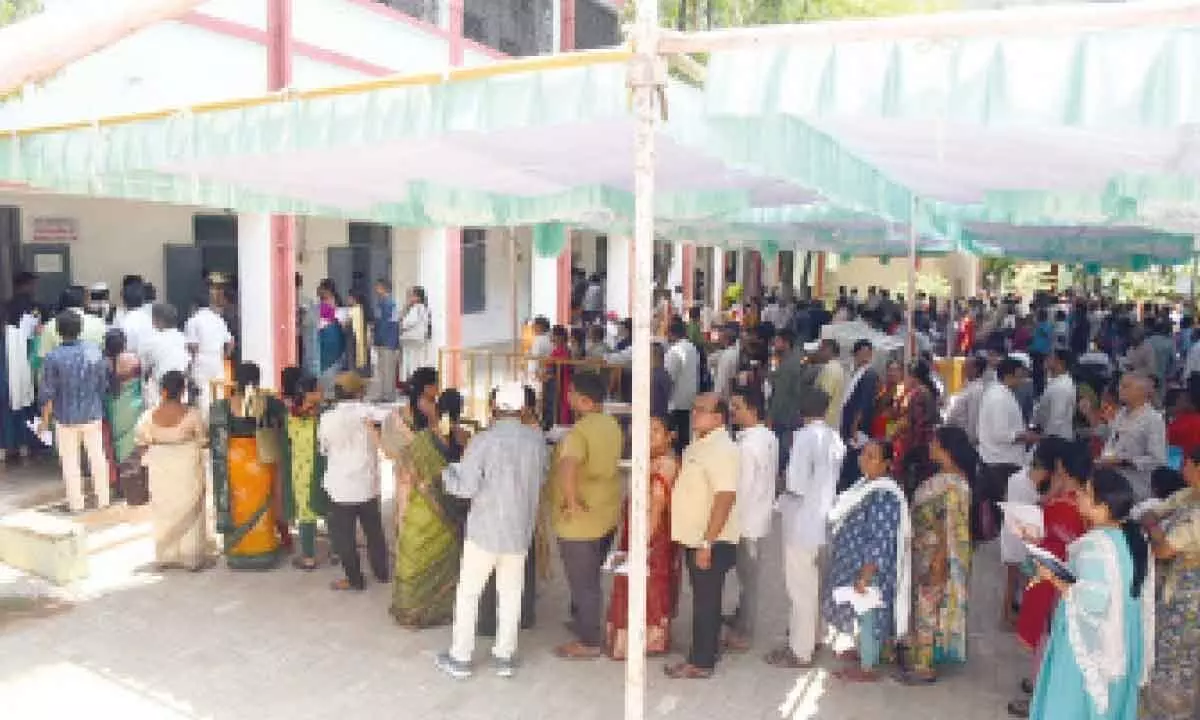 Employees waiting in queue line to cast their votes at a facilitation centre in Tirupati on Sunday