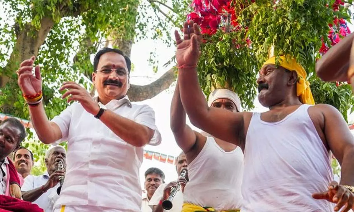 Delhi BJP President Virendra Sachdeva dances with folk  artists during the Delhi Tamil Sangamam organised by Delhi BJP, in New Delhi on Sunday