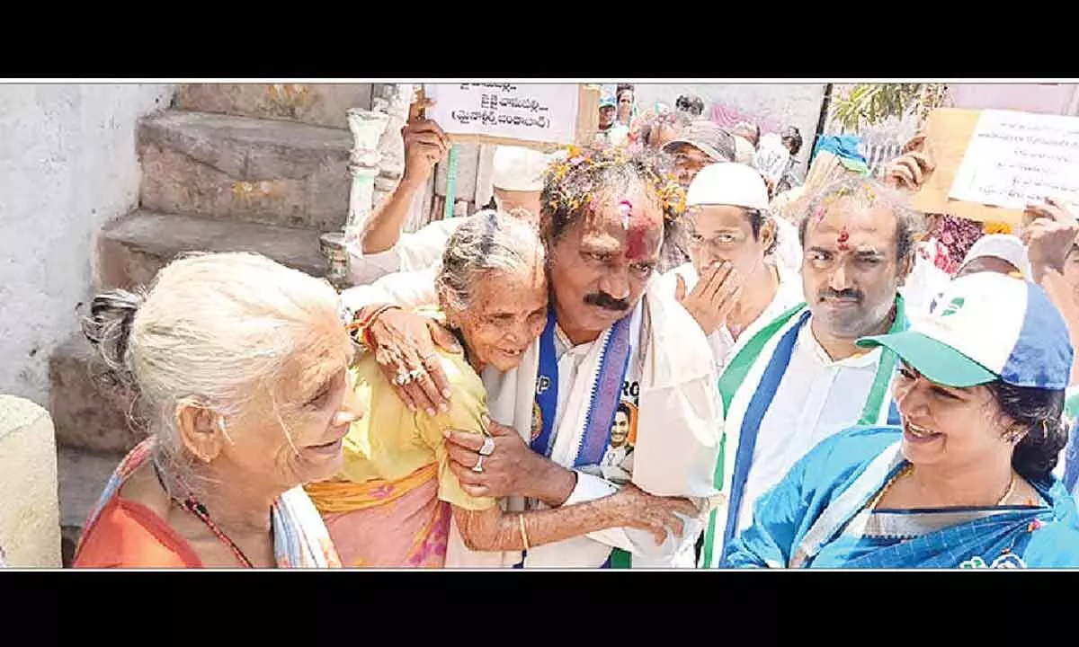 YSRCP south segment MLA candidate Vasupalli Ganesh Kumar giving a warm hug to an elderly woman during his poll campaign in Visakhapatnam