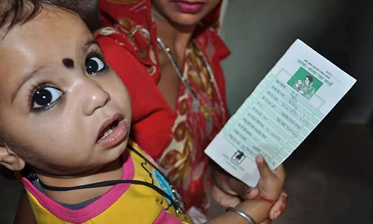 A child holding his vaccination card at a health facility in Rajasthan, India. Credit: Steve Stewart, CDC.