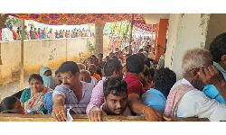 Voters waiting in  queue lines at Polling Booths 9 andd 10 in Mukthinuthalapadu of Ongole assembly constituency  to exercise their right to vote on Monday