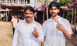 Parchuru MLA Yeluri Sambasiva Rao and his son Divyesh cast their votes at Polling Booth No 44 in Isukadarsi of Parchuru assembly