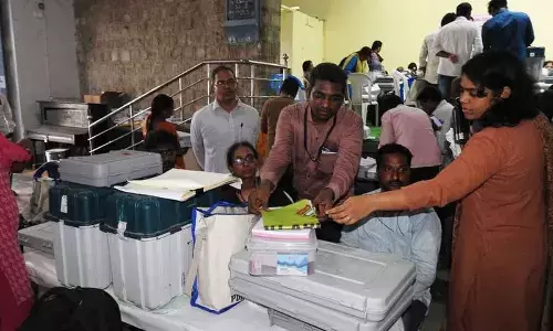 GMC Commissioner and Guntur East Assembly constituency returning officer Kirthi Chekuri distributing polling material to the polling officials at Facilitation Centre set up at AC College in Guntur on Sunday