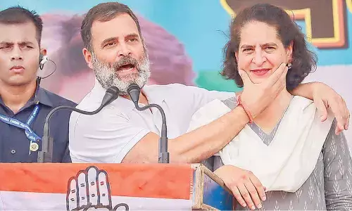 Congress leader Rahul Gandhi expresses his gratitude to his sister Priyanka Gandhi during a public meeting for Lok Sabha elections, at Maharajganj in Rae Bareli on Monday