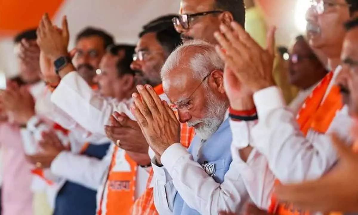 Prime Minister Narendra Modi with Uttar Pradesh Deputy Chief Minister Brajesh Pathak and others during a public meeting for the Lok Sabha elections, in Hamirpur district on Friday