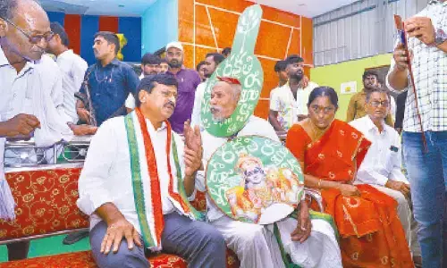 Minister Ponguleti Srinivas Reddy listening to Vanajeevi Ramaiah during his tour in Khammam rural mandal on Sunday.