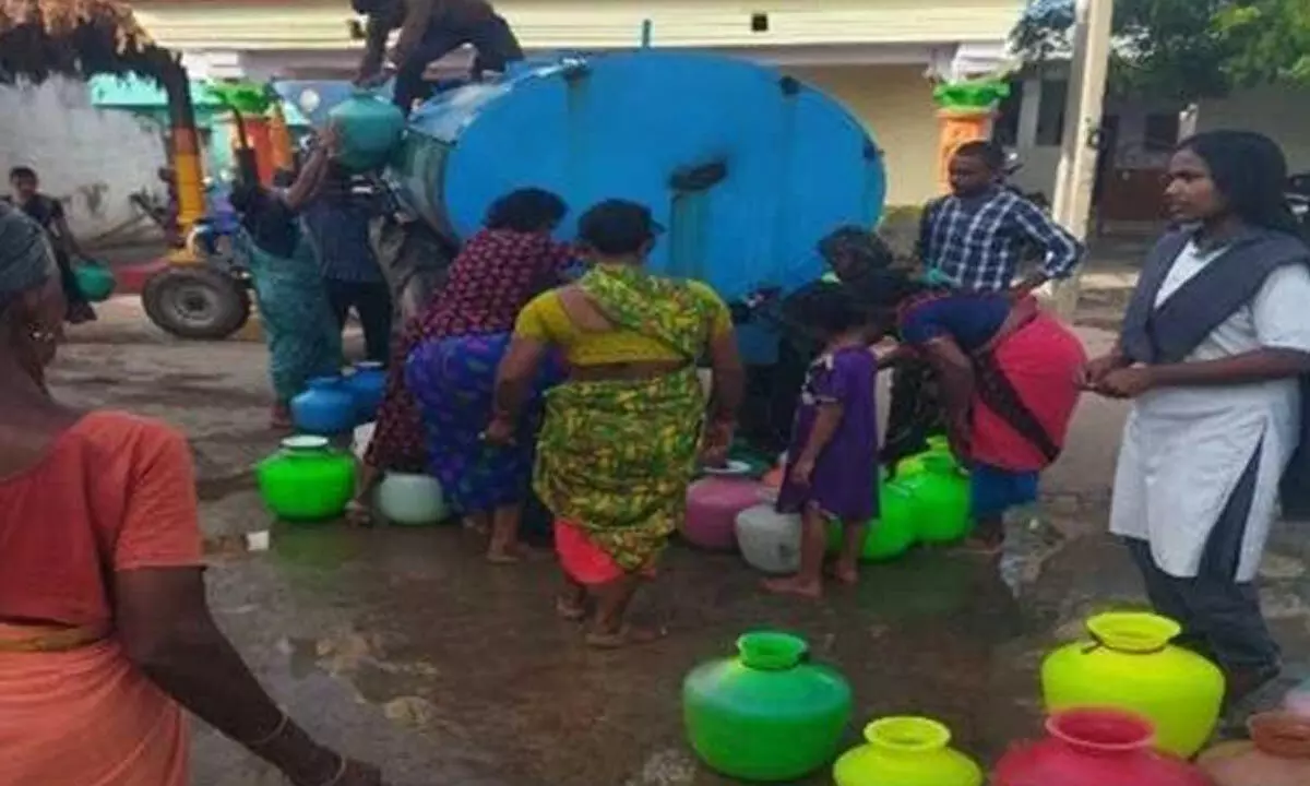 Public filling their plastic pots from tanker supplied by RWS&S department in Timmapuram of Dornala mandal on Monday