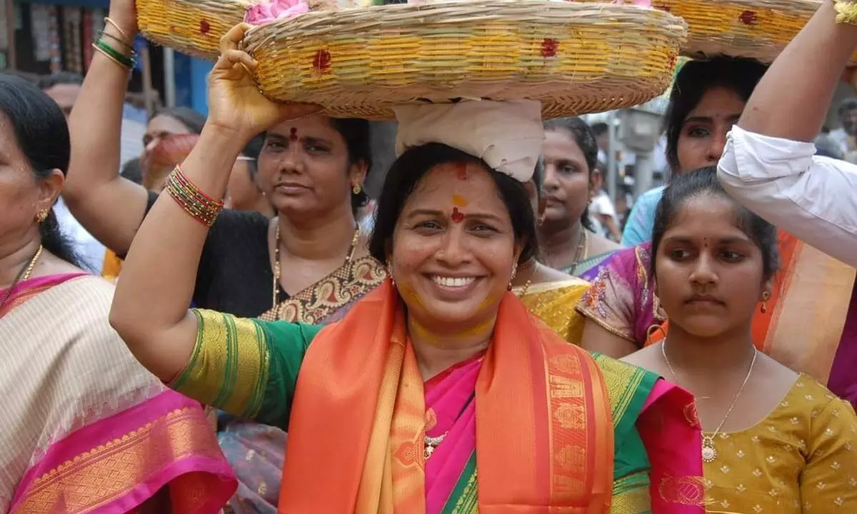 Mayor Dr R Sirisha carrying ‘sare’ to present to goddess Gangamma, in Tirupati on Monday