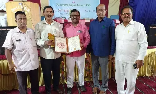 District School Education Officer K Vasudeva Rao and other officials congratulating Madduru ZP High School mathematics teacher K Sita Ramanjaneyulu