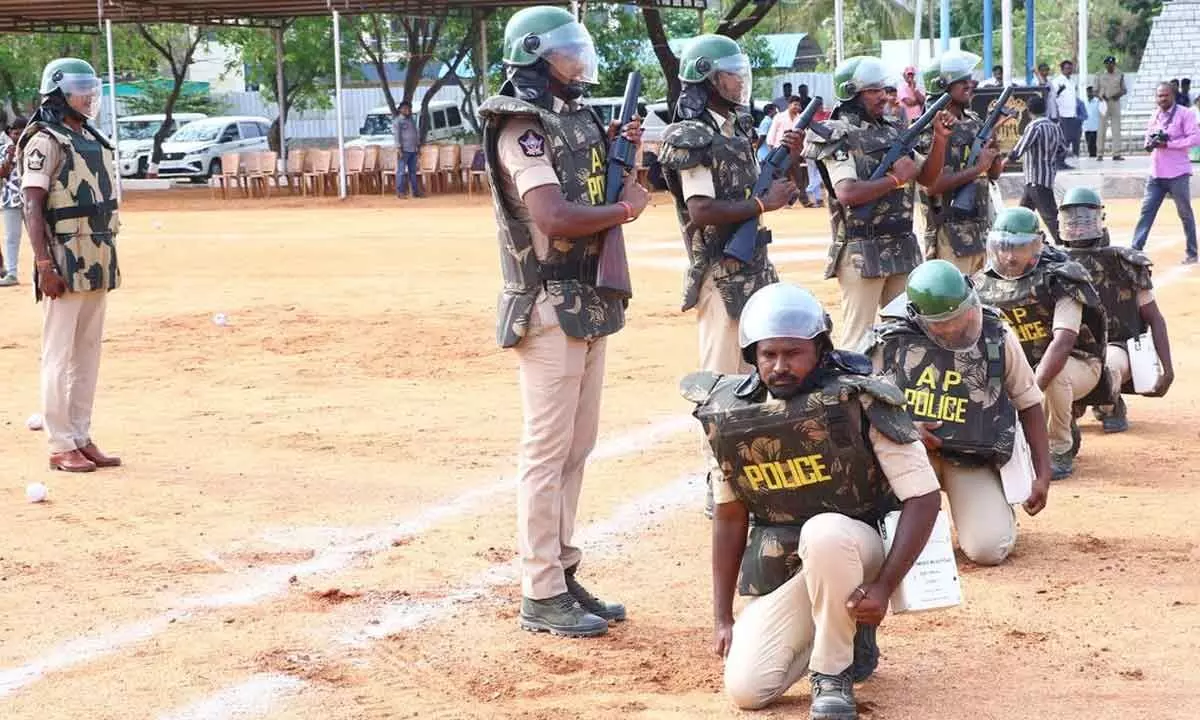 Police personnel conducing mock drill at police parade grounds in Tirupati on Thursday