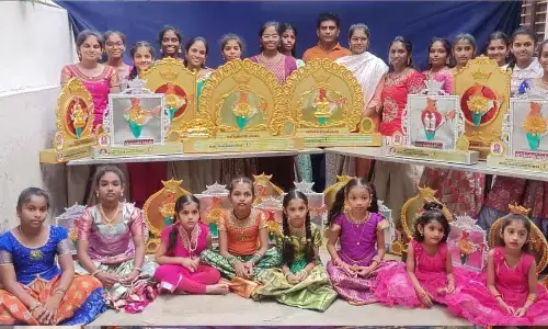 Chandu Dance Academy students displaying the prizes won in the national-level dance competition, at their academy in Ongole on Sunday