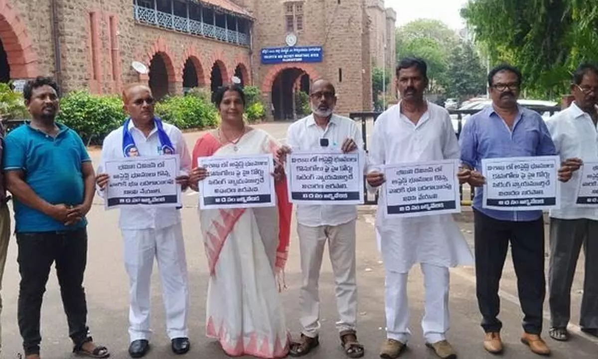 Representatives of Visakha District Dalit Unity Forum displaying placards as a mark of protest in Visakhapatnam on Monday