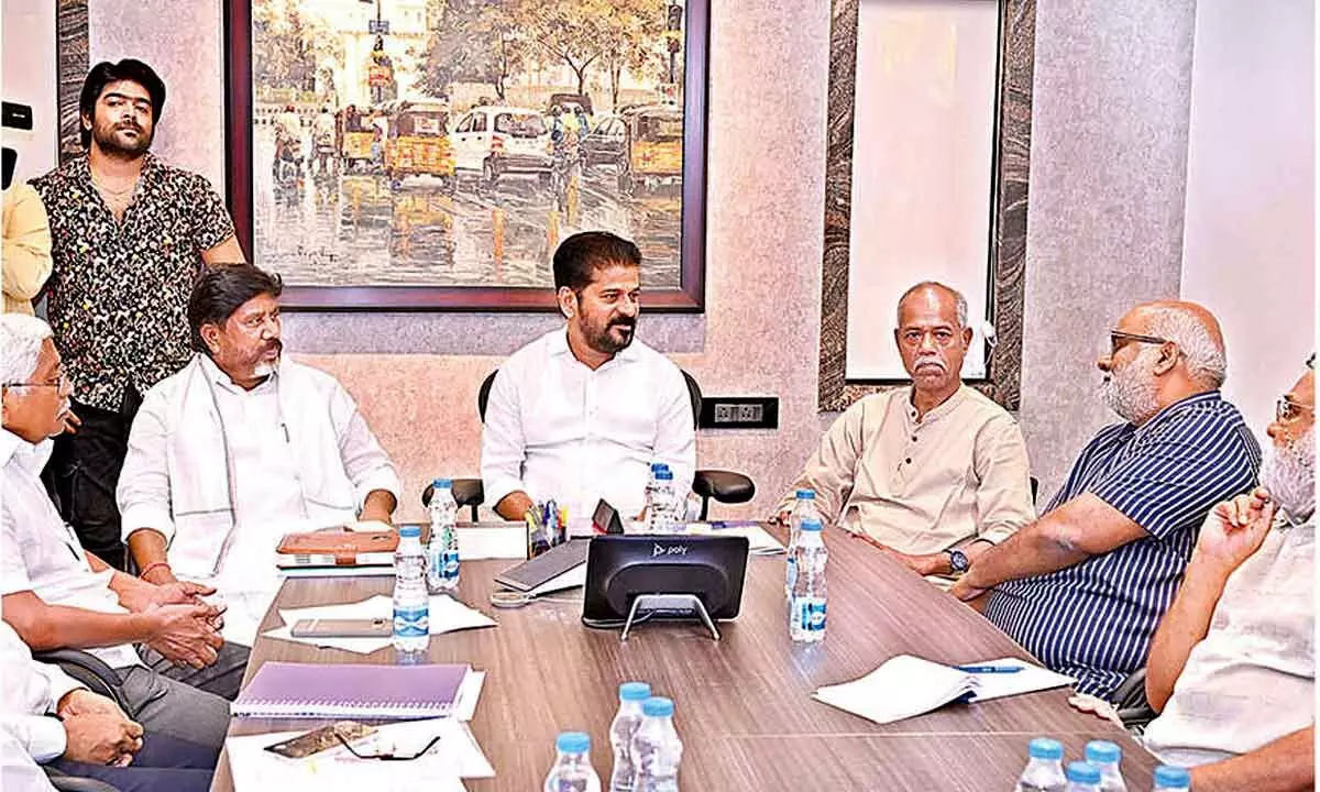 Chief Minister A Revanth Reddy in a jovial mood with Deputy CM Bhatti Vikramarka after finalising State Emblem and Song with song writer Andesri, Oscar award winner MM Keeravani and other artists in Hyderabad on Wednesday