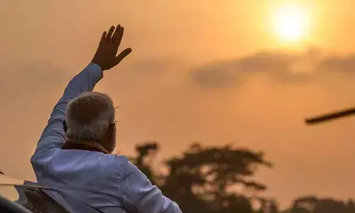 Prime Minister Narendra Modi waves to supporters during a public meeting ahead of the seventh phase of Lok Sabha  elections, in Kendrapara district on Wednesday