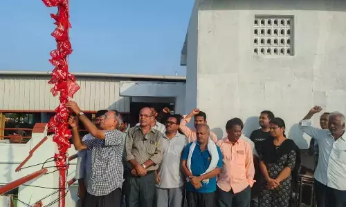 CITU leaders hoisting the flag on the occasion of its 70th  Formation Day, in the office premises in Tirupati on Thursday
