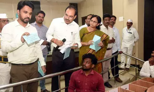 Collector V Prasanna Venkatesh explaining a point to officials at postal ballot counting training programme in Eluru on Thursday
