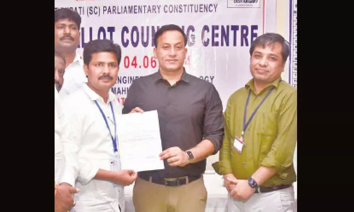 Tirupati YSRCP MP candidate receiving declaration certificate from Returning Officer and District Election Officer Pravin Kumar