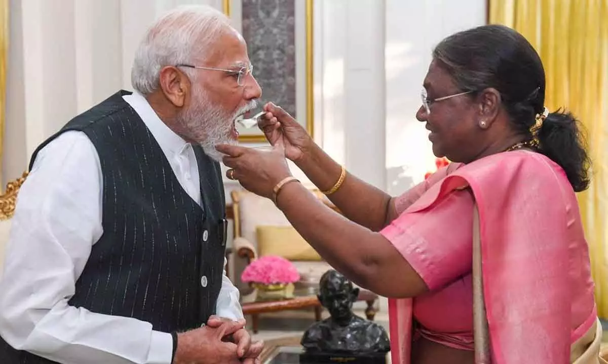 Droupadi Murmu offers curd to NDA Parliamentary Party leader Narendra Modi after appointing the latter as Prime Minister-designate during a meeting at the Rashtrapati Bhavan ahead of government formation, in New Delhi