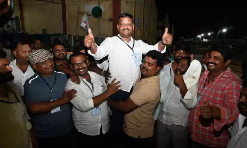 Congress MLC by pol candidat. Tenmar allannae showing victory symbol in the premises of MLC votes counting center in Nalgonda