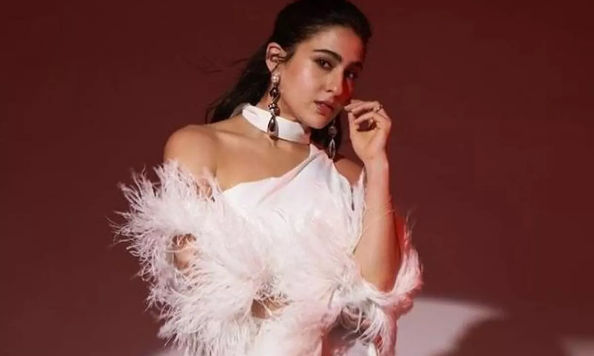 Sara Ali Khan dazzles in white thigh-high slit gown with feather sleeves, dewy makeup