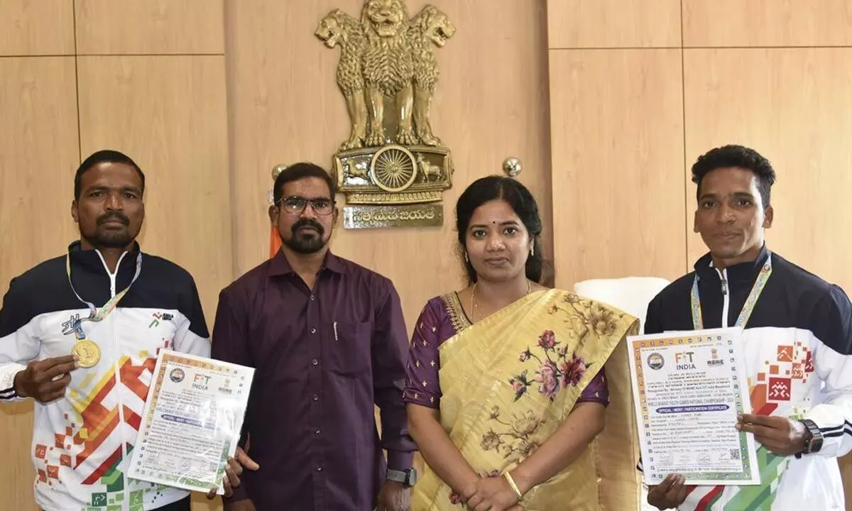Alluri Sitarama Raju district collector M Vijaya Sunitha congratulating two athletes who won gold medals in the national-level running competition on Monday