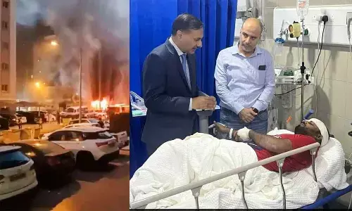 (L) Smoke billows after a fire broke out in a building, in Mangaf, Kuwait on Wednesday. The Indian diplomat met a number of patients and assured them of full assistance