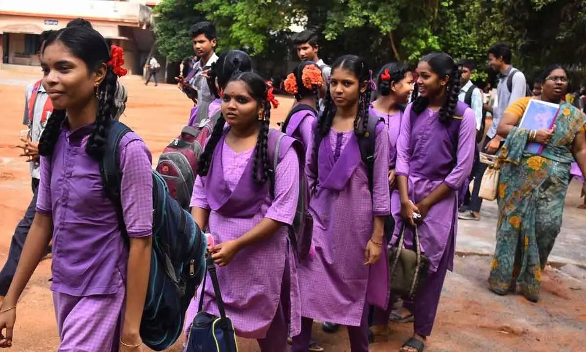 Students attending schools after summer holidays and meet friends in Vijayawada on Thursday  ( Hans photo Ch Venkata Mastan )