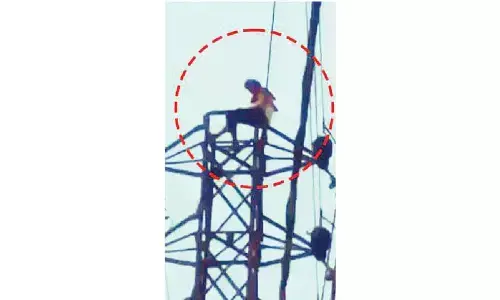 Man climbs electricity tower after argument with wife