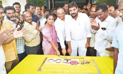 MLA Md Naseer Ahmed and Galla Madhavi cutting cake in Guntur on Thursday